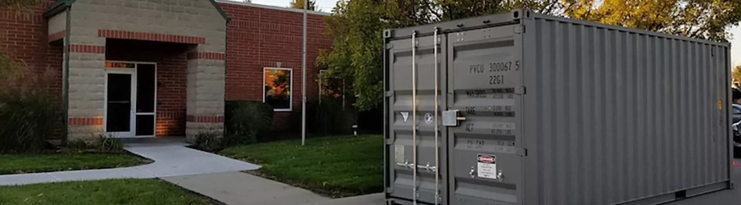 Storage container sitting in front of a building