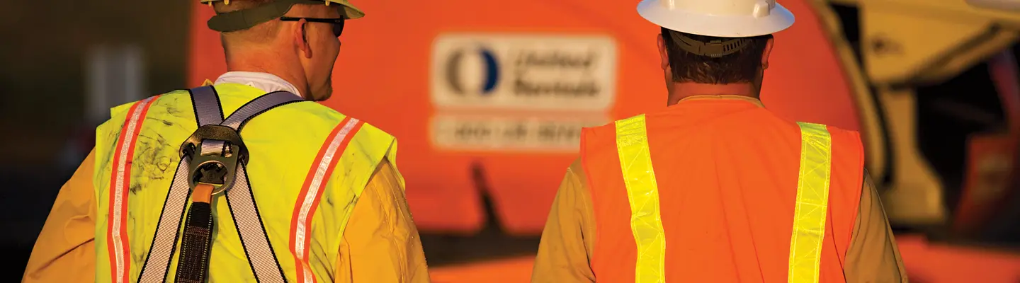 Two workers wearing personal protective equipment