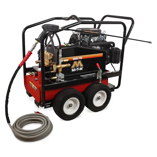 Black and red Mi-T-M 5,000 psi pressure washer being used to wash a piece of heavy machinery